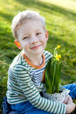 Smiling boy holding a potted plant of flowers on Fabric Genomics